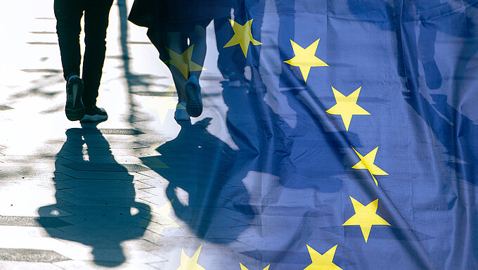 EU or European Union Flag and shadows of people, concept political picture.